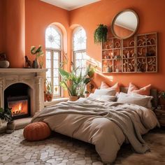 a bedroom with an orange wall and fireplace in the corner is decorated with potted plants