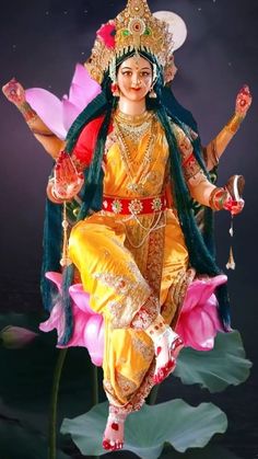 a statue of the hindu goddess sitting on top of a lotus flower in front of a dark background