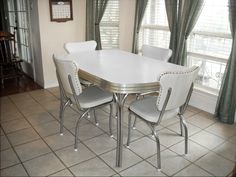 a white table and chairs in a room