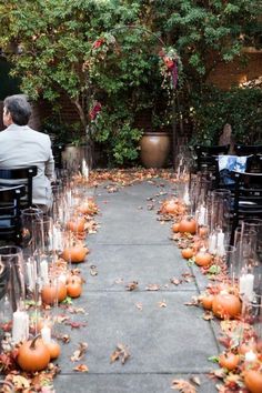 an outdoor ceremony with candles and pumpkins