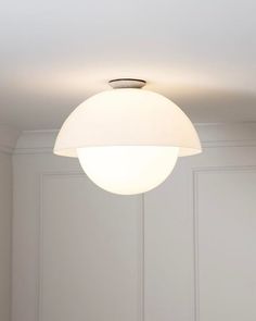 a white light hanging from the ceiling in a room