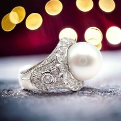 About This Piece: This Vintage Estate 18k White Gold Diamond 12.5mm Pearl Ring features a large, lustrous 12.5mm pearl set in a beautifully crafted 18k white gold cocktail ring. The pearl is accentuated by a halo of sparkling diamonds, adding a touch of elegance and sophistication to this timeless piece. Metal: 18k White Gold Stone: Diamonds: Approx 2ctw Size: 6, Resize Available Pearl: Bluish Silver High Luster 12.5mm Pearl Weight: 13.1g Hallmarks: 18k 89192 3227medd Pearl Cocktail Ring, Chanel Ring, Watch Cufflinks, Hermes Jewelry, Gold Cocktail Ring, Gold Cocktail, Pearl Set, Gold Stone, Cartier Ring