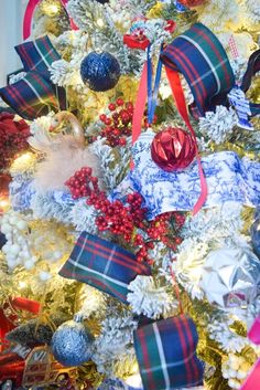 a decorated christmas tree with red, white and blue ornaments