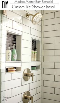 a bathroom with white subway tile and gold faucet shower head in the corner