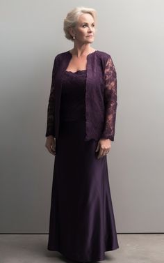 an older woman wearing a purple dress and jacket