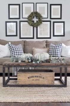 a living room filled with lots of furniture and pictures on the wall above it's coffee table