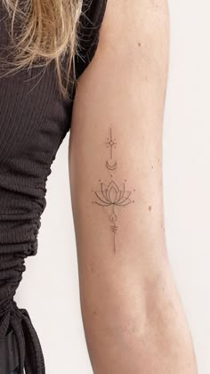 a woman's arm with a tattoo on it and a cross in the middle