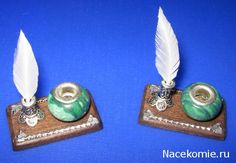 two small green and white objects with feathers on them