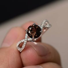 This is a gorgeous handmade creation. Its beauty is its simplicity & Elegance. The 7*7 mm round shape faceted natural Smoky Quartz is crafted in solid sterling silver and with rhodium plated. All item is sent in a beautiful gift box If you have any idea of design your ring,pls contact me directly. You can realize more lovely stuff clicking the link https://www.etsy.com/shop/knightjewelry?refshopsection_shophome_leftnav Please leave the correct address and you phone number for delivering succ Proposal Rings, Garnet Wedding Rings, Silver Promise Rings, Swiss Blue Topaz Ring, Brown Gemstone, Rings Sterling Silver, Smoky Quartz Ring, Diamond Wedding Rings Sets, Engagement Ring Cuts