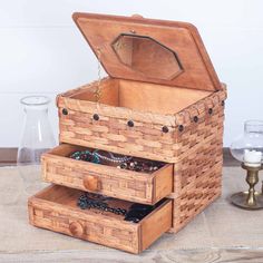 an open wooden chest with jewelry in it