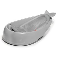 a baby bath tub with a whale design on the top and bottom, sitting in front of a white background