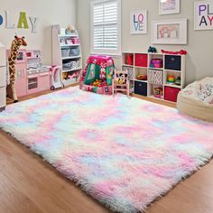 a child's bedroom with pink, blue and white rugs