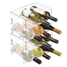 several bottles of wine are in a clear holder