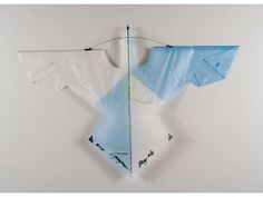 an origami kite hanging on the wall