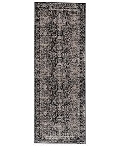 a black and white rug with an ornate design on the bottom, in front of a white background