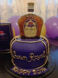 a birthday cake with a bottle of liquor on top