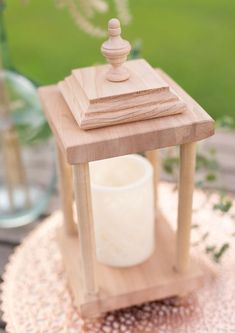 a small wooden stand with a candle on it