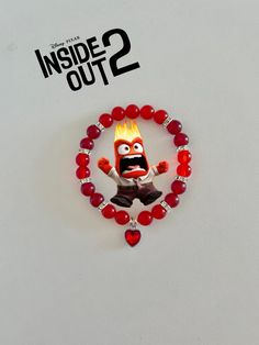 the inside out 2 movie poster is displayed on a white background with red beads and a cartoon character