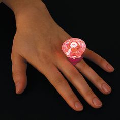 a person's hand with a ring on it that has an image of a dog