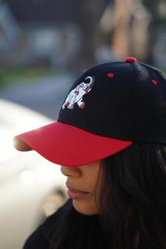 With unique designs you won't find anywhere else, our caps are the quality type that are designed with a thicker woven fabric. Not those flimsy weak ones that lose shape. 6-Panel. 100% stitched embroidered design. Curved brim. Dry clean only. Comes in: Velcro Adjust back. Perfect for those Devastating Divas who need a cap for all casual, sports and/or fitness occasions. Black Embroidered Logo Baseball Cap, Black Embroidered Fitted Cap, Embroidered Black Fitted Cap, Black Embroidered Cotton Trucker Hat, Embroidered Black Baseball Cap, Black Embroidered Baseball Cap With Curved Brim, Black Embroidered Baseball Cap For Streetwear, Black Embroidered Dad Hat, Embroidered Black Baseball Cap For Streetwear