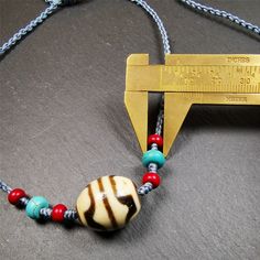 ❤This necklace was hand-woven by Tibetans from Baiyu County, the main bead is a lotus dalo dzi bead, paired with turquoise and agate beads,about 40 years old.It can be worn not only as a fashionable accessory but also holds cultural and religious significance.The length of the necklace can be adjusted, the maximum circumference is about 60cm.Dzi beads are precious jewelry from Tibetan culture which are believed to possess the power of bringing good fortune to the owners.You'll get 1pc necklace a Adjustable Traditional Turquoise Necklace With Large Beads, Adjustable Amulet Style Jewelry With Wooden Beads, Amulet Style Beaded Necklace With Round Wooden Beads, Amulet Style Wooden Beaded Necklace, Adjustable Turquoise Amulet Necklace, Handmade Turquoise Amulet Necklace With Round Beads, Adjustable Wooden Beads Amulet Jewelry, Adjustable Wooden Bead Amulet Jewelry, Spiritual Hand-strung Turquoise Necklace With Round Beads