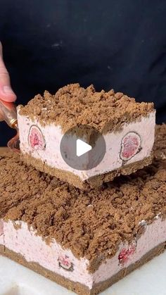 someone is cutting into a piece of cake that looks like it has eyes on it