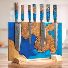 the knife holder is made out of wood and has five knives in it