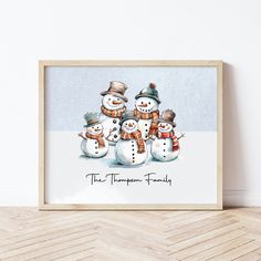 a family of four snowmen standing next to each other in front of a white wall