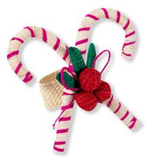 two candy canes are wrapped in red and white yarn