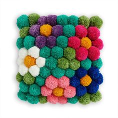 multicolored pom - poms are arranged in the shape of a square