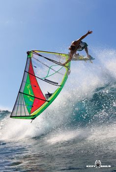 a man riding a kiteboard on top of a wave in the ocean