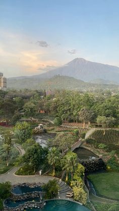 an aerial view of a park with mountains in the background