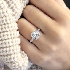 a woman's hand with a diamond ring on it