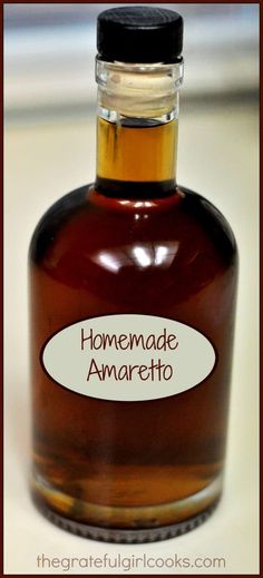 a bottle of homemade amarettoa sitting on a counter top with the label above it