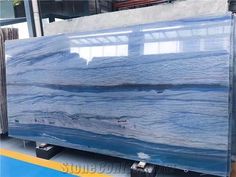 a large blue marble slab sitting on top of a metal stand in a warehouse area