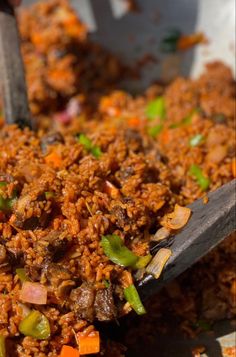 a bowl filled with meat and vegetables on top of a table