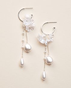 Our Morena Dangle Earrings are designed to be one-of-a-kind floral dangle hoops that will have everyone asking "where did you get those?!" Crafted with off white flower clusters & dangling freshwater pearl beads, these earrings are perfect for casual or formal wear. Freshwater pearls, off white flowers, & pearl-like beads 1" x 3.25" length Hypoallergenic, lead-free & nickel-free Style #4389 Delicate Dangle Flower Earrings, White Sterling Silver Dangle Flower Earrings, Feminine Silver Dangle Flower Earrings, Silver Dangle Flower Earrings, Silver Flower Dangle Earrings With Beads, Dangle Earrings Outfit, Earrings Outfit, Micro Crochet, Gold Bridal Earrings