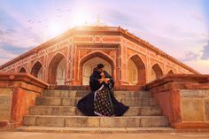 a man and woman are sitting on some steps