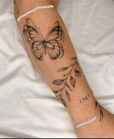 a woman's arm with a butterfly tattoo on it