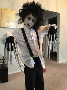 a man dressed up as michael jackson in a living room with fake hair and makeup