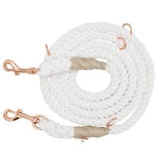 a white rope with copper hardware on a white background, the rope is being held by two