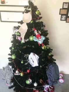 a black christmas tree with an elf on it