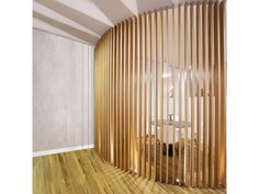 a room with wooden slats on the wall and wood flooring in front of it