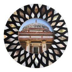 a circular mirror with an image of a building in the center