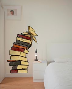 a bed room with a neatly made bed and a large stack of books on the wall