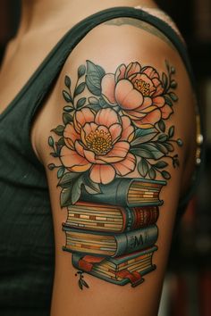 a woman's arm with books and flowers on it