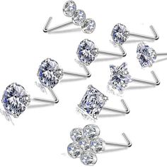 six pairs of diamond nose studs with four different shapes and sizes on each ear