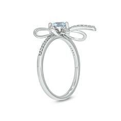 Wrap your love in this sweet aquamarine and diamond bow ring. Sterling silver The sculpted bow shimmers with diamond-touched and polished ribbons A 5.0mm heart-shaped blue aquamarine centers the design Additional diamonds line the shank 1/6 ct. t.w. of diamonds Fine Jewelry With Bow For Anniversary, Fine Jewelry Bow For Anniversary, Luxury Bow Jewelry For Anniversary, Elegant Bow Rings For Anniversary, White Gold Bow Rings For Anniversary, Diamond Jewelry With Bow For Anniversary, White Gold Bow Rings For Wedding, Silver Wedding Ring With Bow Detail, Fine Jewelry Anniversary Bow Jewelry