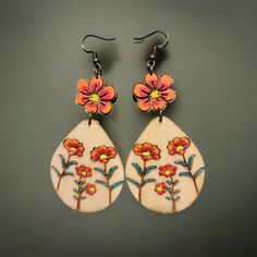 Boho Floral Wooden Earrings – Hand-Painted & Nature-Inspired Celebrate your love of nature with these beautiful wooden earrings featuring hand-painted floral motifs. Each flower is carefully engraved and painted on lightweight wood treated with linseed oil for durability. These 2-inch long earrings are the perfect accessory for you who embrace a minimalist and bohemian style without losing elegance. The picture may not reflect the actual color of the items due to differences in screen's pixel. Artsy Hand Painted Flower Jewelry, Artsy Hand Painted Flower Earrings, Bohemian Multicolor Floral Print Earrings, Unique Hand Painted Flower Drop Earrings, Bohemian Drop Earrings With Floral Print, Bohemian Floral Print Drop Earrings, Bohemian Hand Painted Flower Earrings, Artistic Hand Painted Flower Earrings, Bohemian Multicolor Hand Painted Flower Earrings