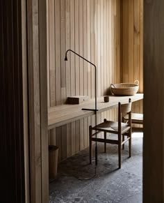 a room with wooden paneling and a table in the corner, along with two chairs